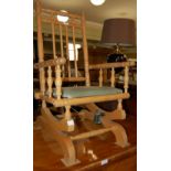 A BLONDE WOOD CHILDS ROCKING CHAIR, VELVET UPHOLSTERED SEAT PAD