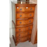 A REPRODUCTION MAHOGANY TALL SERPENTINE CHEST OF SIX COCKBEADED DRAWERS