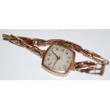 A VINTAGE 9CT GOLD CASED LADIES WRISTWATCH WITH BLACK AND SILVERED ARABIC NUMERAL DIAL AND