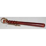 A VINTAGE TRUNCHEON WITH LEATHER STRAP