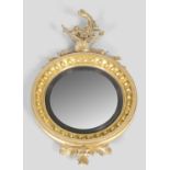 A 19th century Regency style giltwood convex wall mirror, the convex mirror plate within ebonised