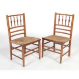A pair of early 20th century Arts & Crafts style stained beech childrens chairs, the upright backs