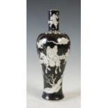 A Chinese porcelain vase, Qing Dynasty, decorated with figures in a fenced garden on a black ground,
