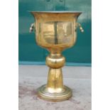 A late 19th century / early 20th century brass pedestal jardiniere, the circular shaped bowl with