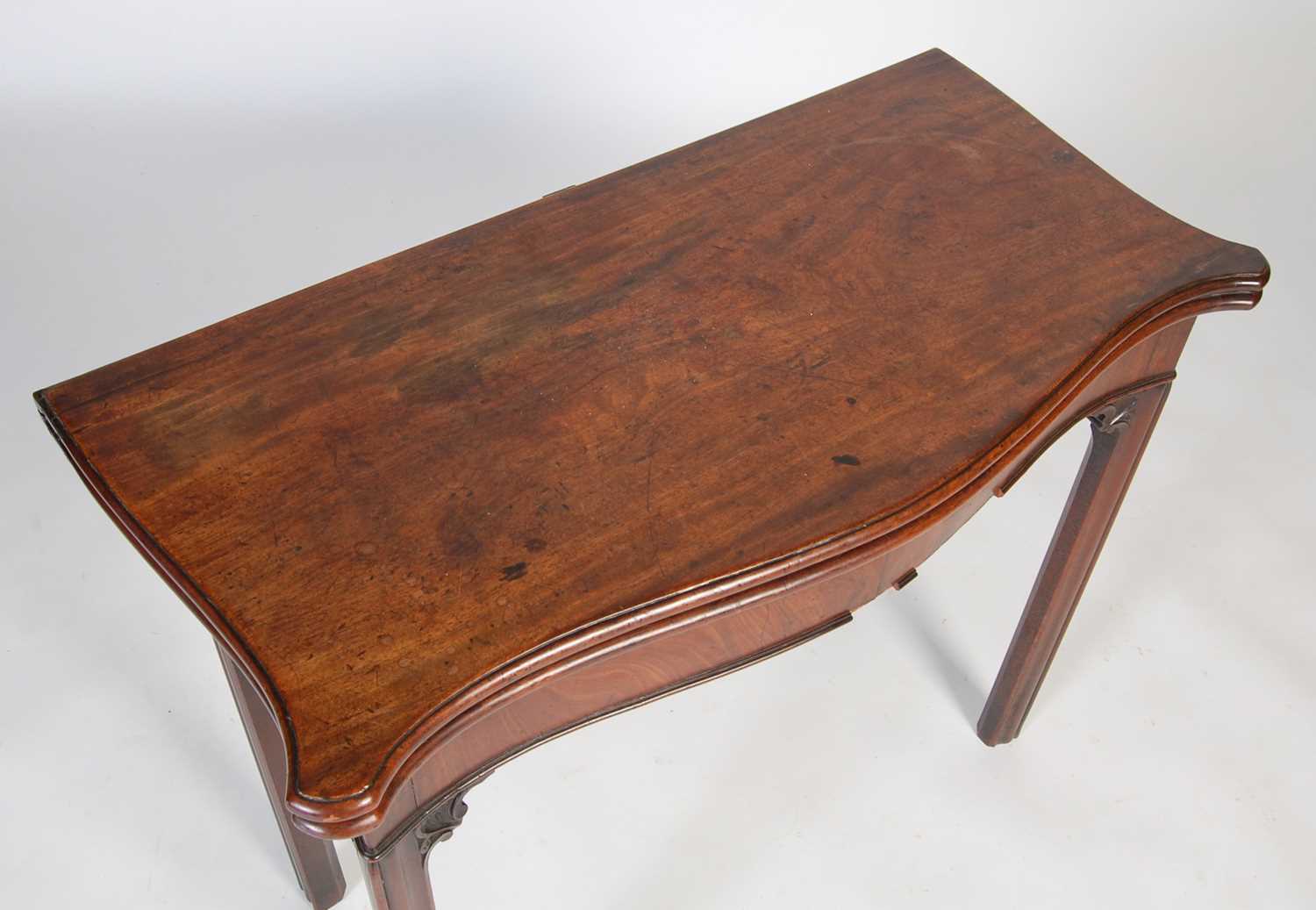 A George III mahogany serpentine card table, the shaped top with moulded edge opening to a green - Image 3 of 12