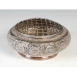 A 20th century white metal Middle-Eastern rose bowl, of circular form embossed with fourteen oval