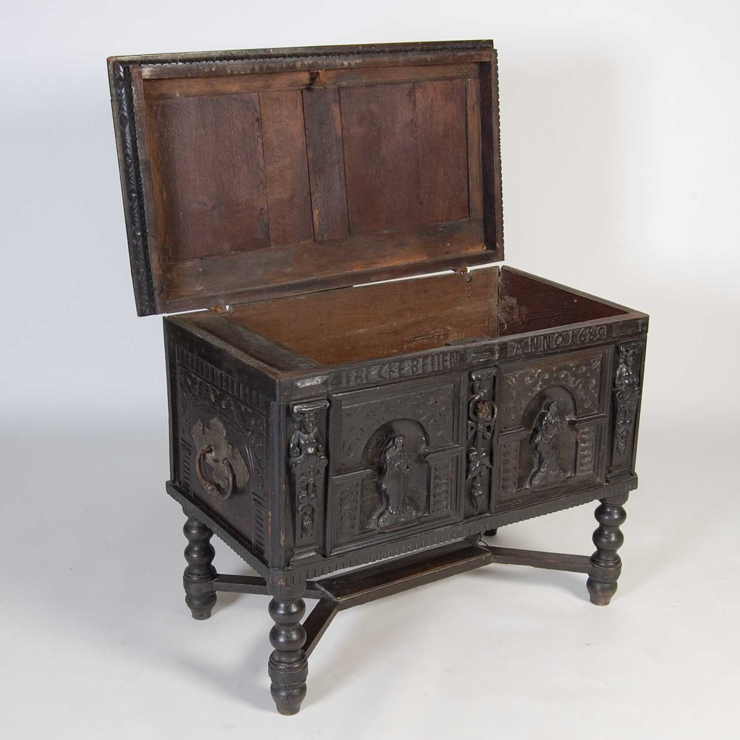 An antique stained oak coffer on integral stand, the hinged cover with two incised figural carved - Image 9 of 13