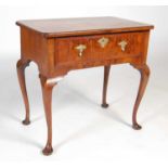 An antique walnut lowboy, the rectangular top with moulded edge and re-entrant corners above a