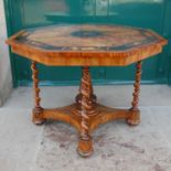 A 19th century walnut and marquetry inlaid octagonal shaped centre table, the top inlaid with an