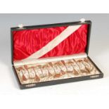 A cased set of twelve early 20th century continental silver gilt egg spoons, with twisted stems