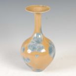 A studio pottery vase, with blue splash decoration on a cafÚ au lait ground, painted with initials