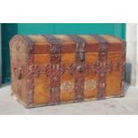 A 19th century stained pine metal bound dome top trunk / chest, the hinged cover opening to a