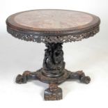 A Chinese dark wood centre table, Qing Dynasty, the circular top with mottled red and white marble