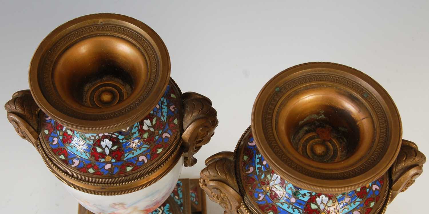 A pair of gilt metal mounted hand-painted porcelain urns, decorated with classical maidens and - Image 8 of 8