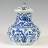 A Chinese porcelain blue and white jar and cover, Qing Dynasty, the lobed body decorated with panels