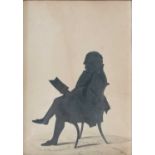 A late 18th/ early 19th century silhouette picture depicting a gentleman reading, with painted