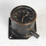 A WWII aircraft cockpit clock, possibly from a Lancaster Bomber, the circular dial with Arabic