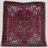 A Persian Heriz rug, 20th century, the rectangular field centred with a blue ground stylised