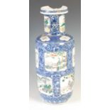 A Chinese porcelain blue and white rouleau vase, Qing Dynasty, decorated with panels of figures,