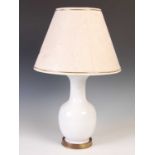 A white glazed ceramic table lamp and shade, on circular brass base, overall 56.5cm high