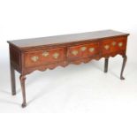A George III oak dresser, the rectangular top with moulded edge above three deep drawers and