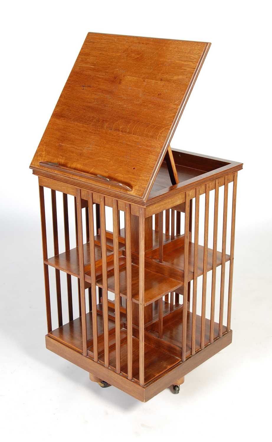 A late 19th/ early 20th century oak revolving bookcase, the square hinged top opening to a book rest - Image 5 of 7