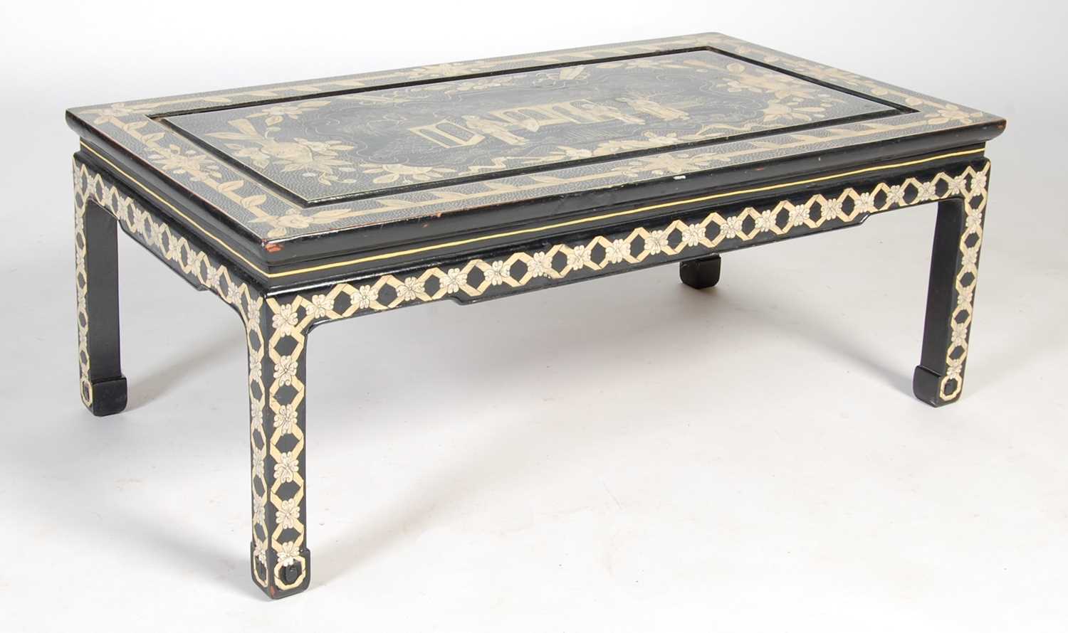 A Chinese black lacquer chinoiserie decorated coffee table, the rectangular top decorated with