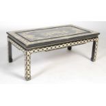 A Chinese black lacquer chinoiserie decorated coffee table, the rectangular top decorated with