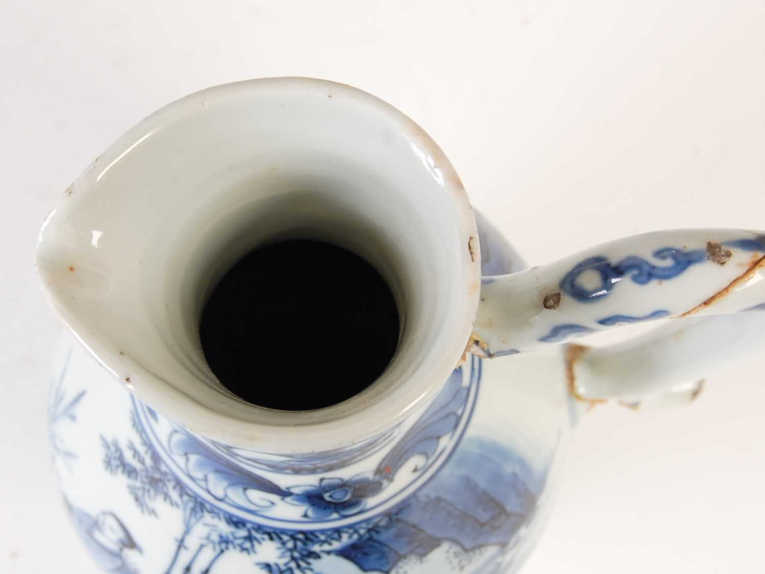 A Chinese porcelain blue and white jug, Qing Dynasty, decorated with three figures in a fenced - Image 9 of 10