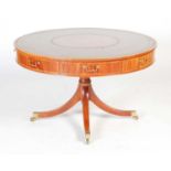 A George III style reproduction mahogany and boxwood lined revolving drum table, the circular top