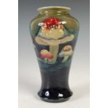Claremont, a Moorcroft vase, decorated with stylised toadstools on a green ground, impressed
