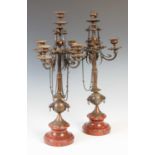 A pair of late 19th century bronze five-light candelabra, mounted on red marble socle bases, 54cm