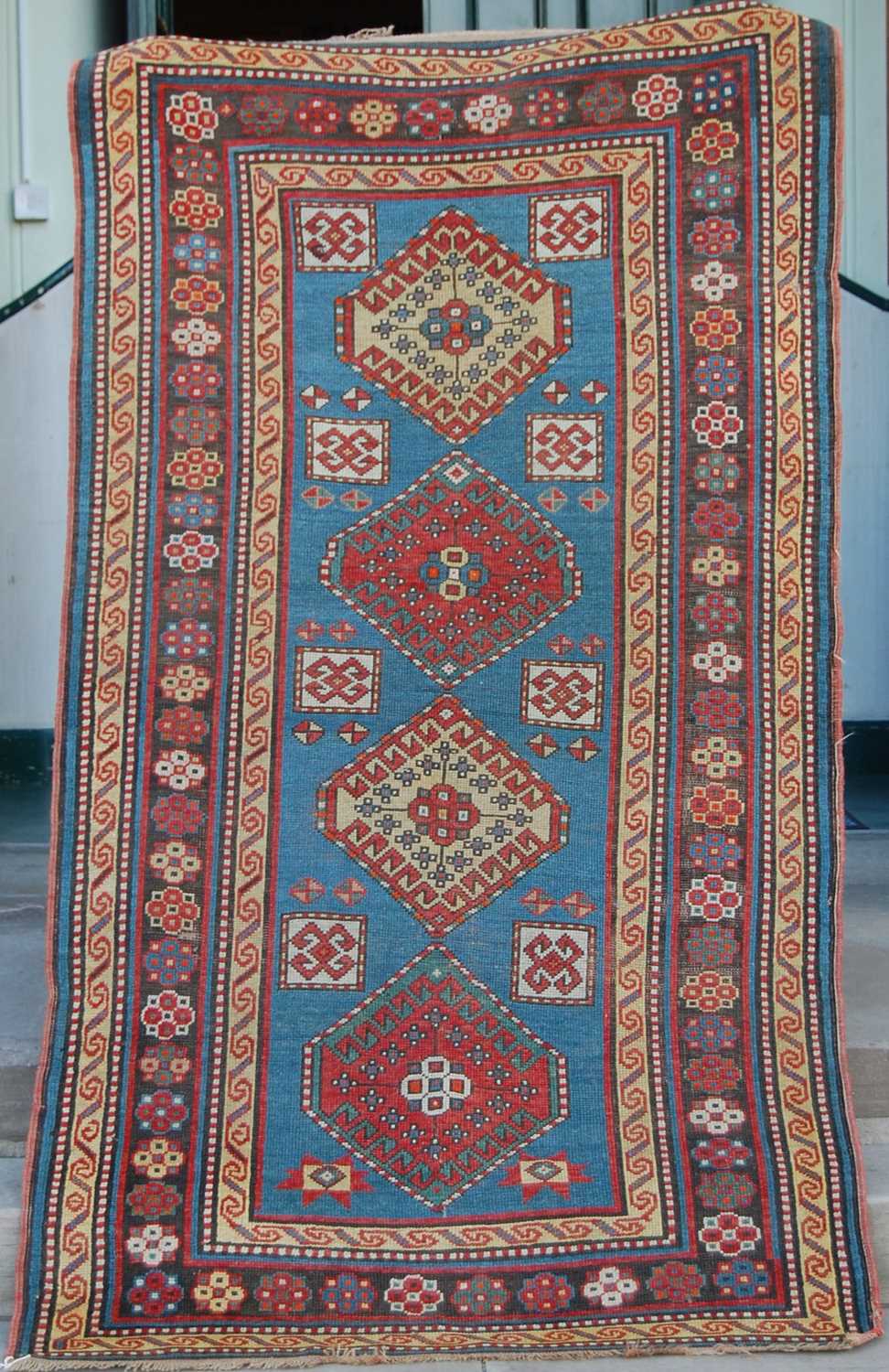 A Persian rug, early 20th century, the rectangular blue ground centred with four lozenge shaped - Bild 2 aus 7