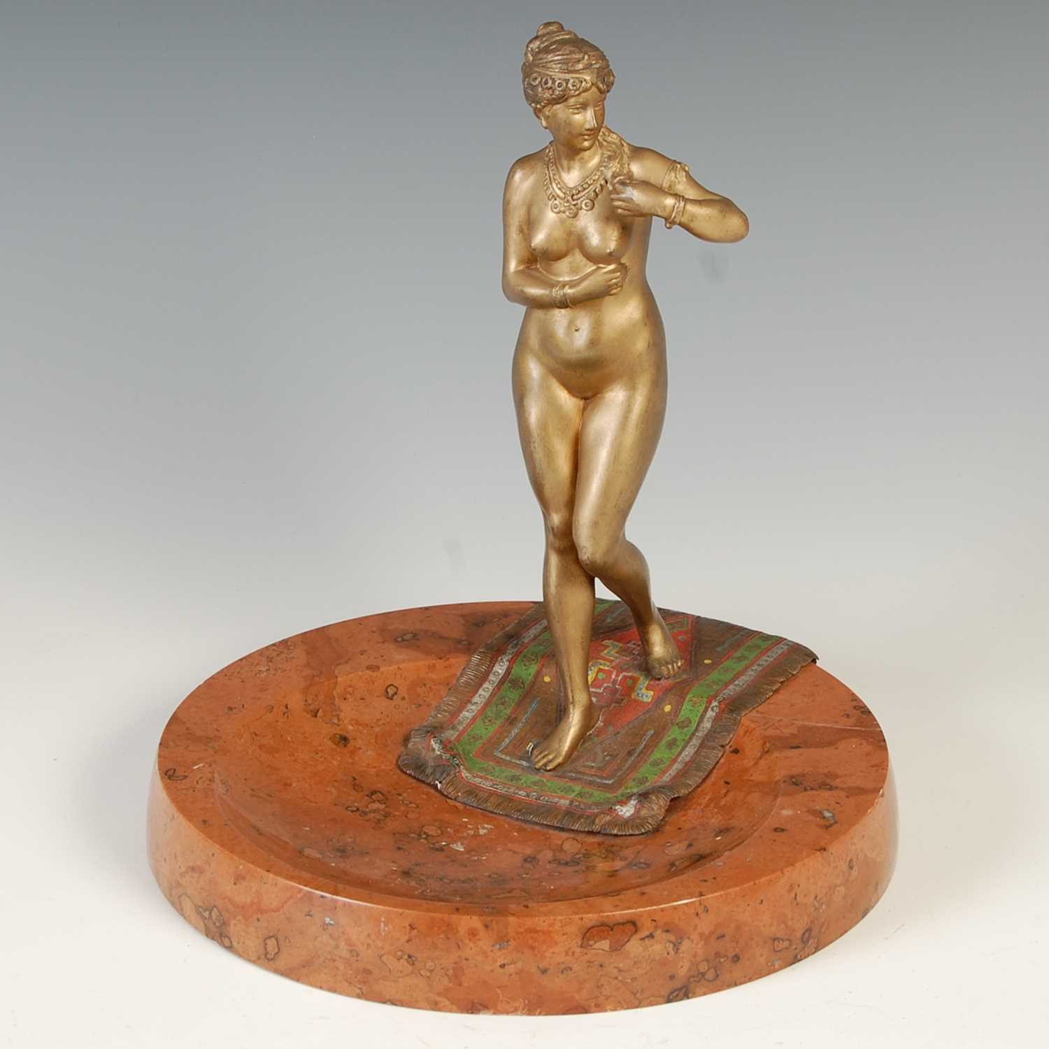 An early 20th century marble and bronze mounted cendrier, mounted with a cold-painted bronze