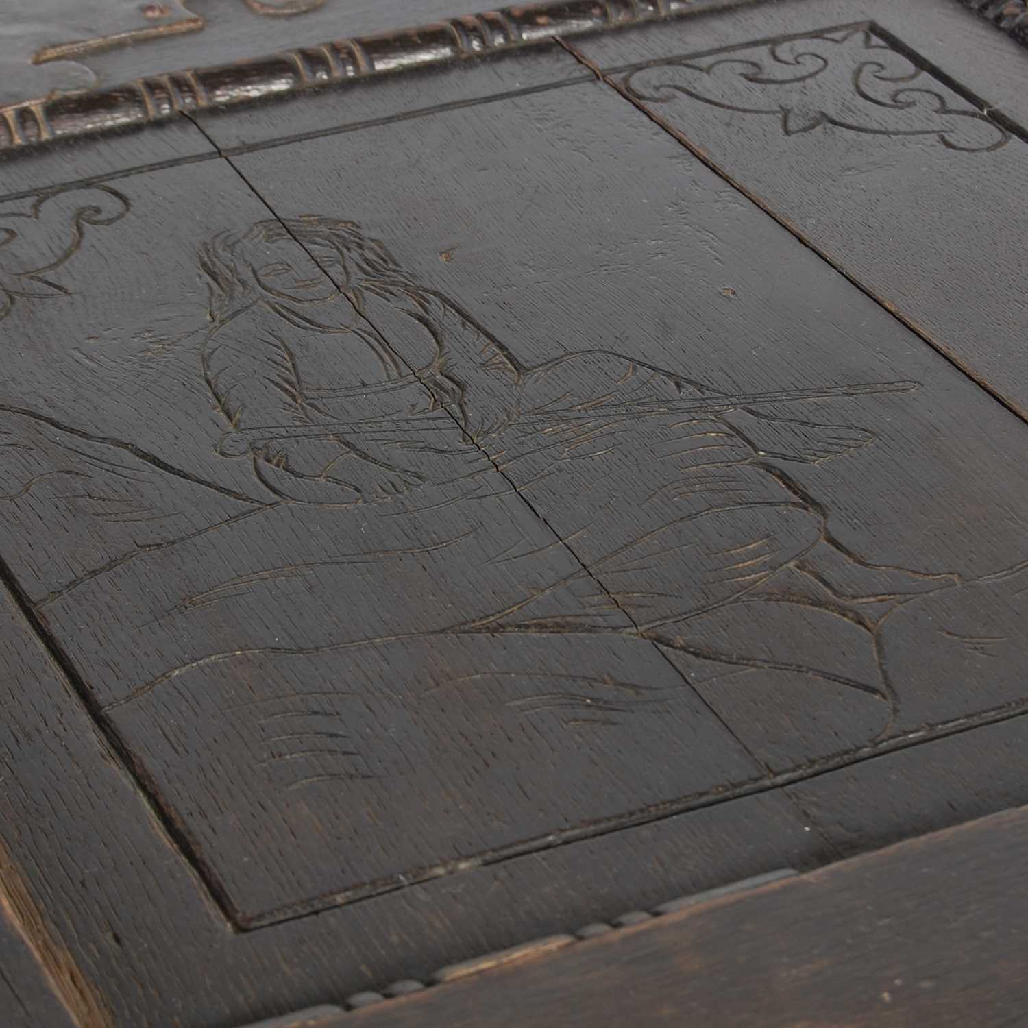 An antique stained oak coffer on integral stand, the hinged cover with two incised figural carved - Image 3 of 13