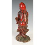 A Chinese carved wood and lacquer figure of a Sage, 31cm high