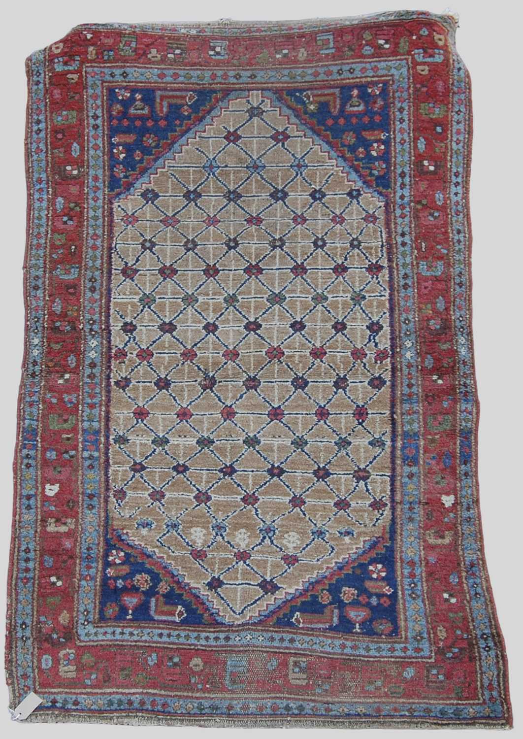 A Persian rug, late 19th/ early 20th century, the rectangular field centred with a lozenge shaped