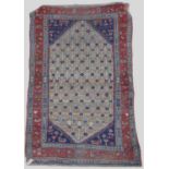 A Persian rug, late 19th/ early 20th century, the rectangular field centred with a lozenge shaped