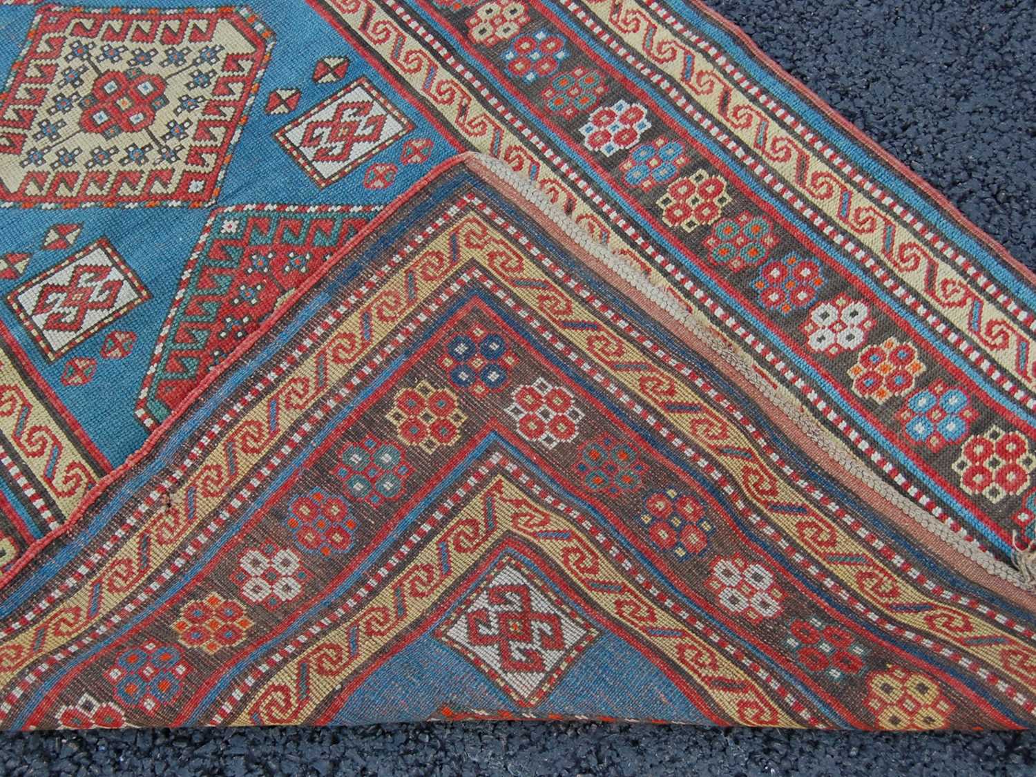 A Persian rug, early 20th century, the rectangular blue ground centred with four lozenge shaped - Bild 4 aus 7