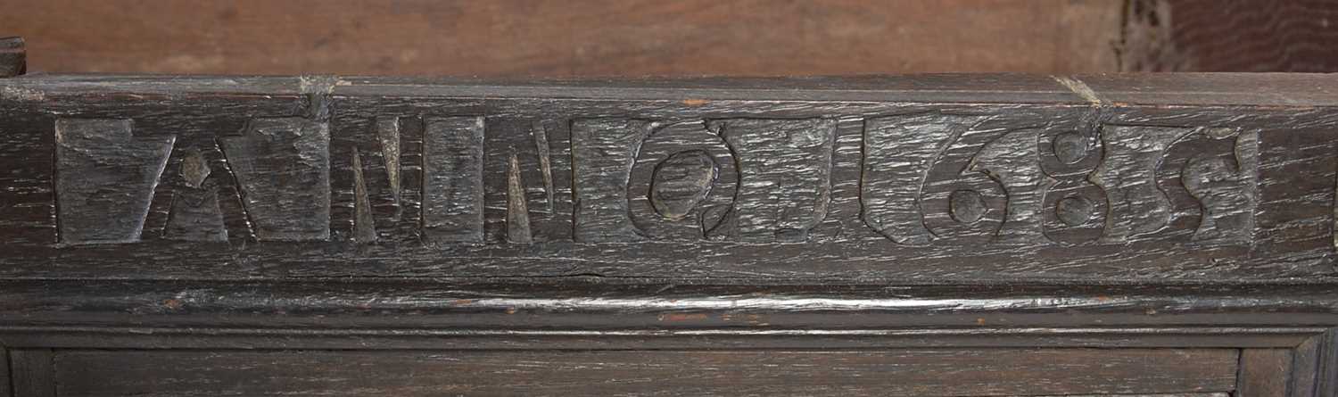 An antique stained oak coffer on integral stand, the hinged cover with two incised figural carved - Image 12 of 13