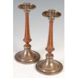 A pair of Arts & Crafts style silver mounted mahogany candlesticks, Birmingham, makers mark of A. E.