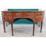 A George III mahogany and boxwood lined demi lune sideboard, the shaped top with fan-shaped line