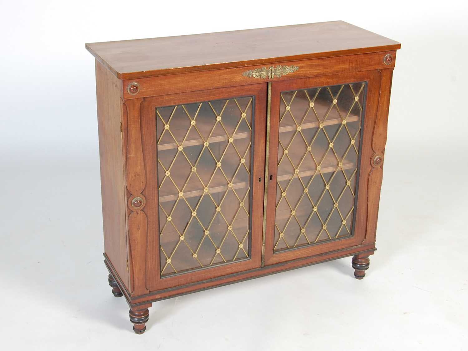 A 19th century mahogany and gilt metal mounted Regency style side cabinet, the rectangular top above