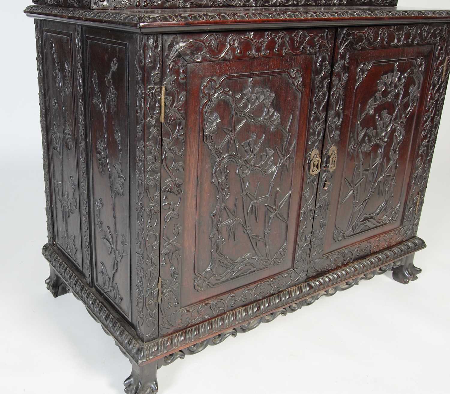 A Chinese dark wood display cabinet/ bookcase, late 19th/ early 20th century, the upper section with - Image 2 of 8