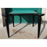 A good quality ebonised and leather card / games table, the top with tan coloured sewn leather