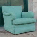 A contemporary green upholstered country house style armchair, with loose cushion seat on tapered
