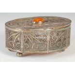 A 20th century white metal filigree work oval-shaped box and cover, the cover centred with oval-