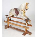 A late 19th/ early 20th century painted pine rocking horse, with later mane and saddle, with