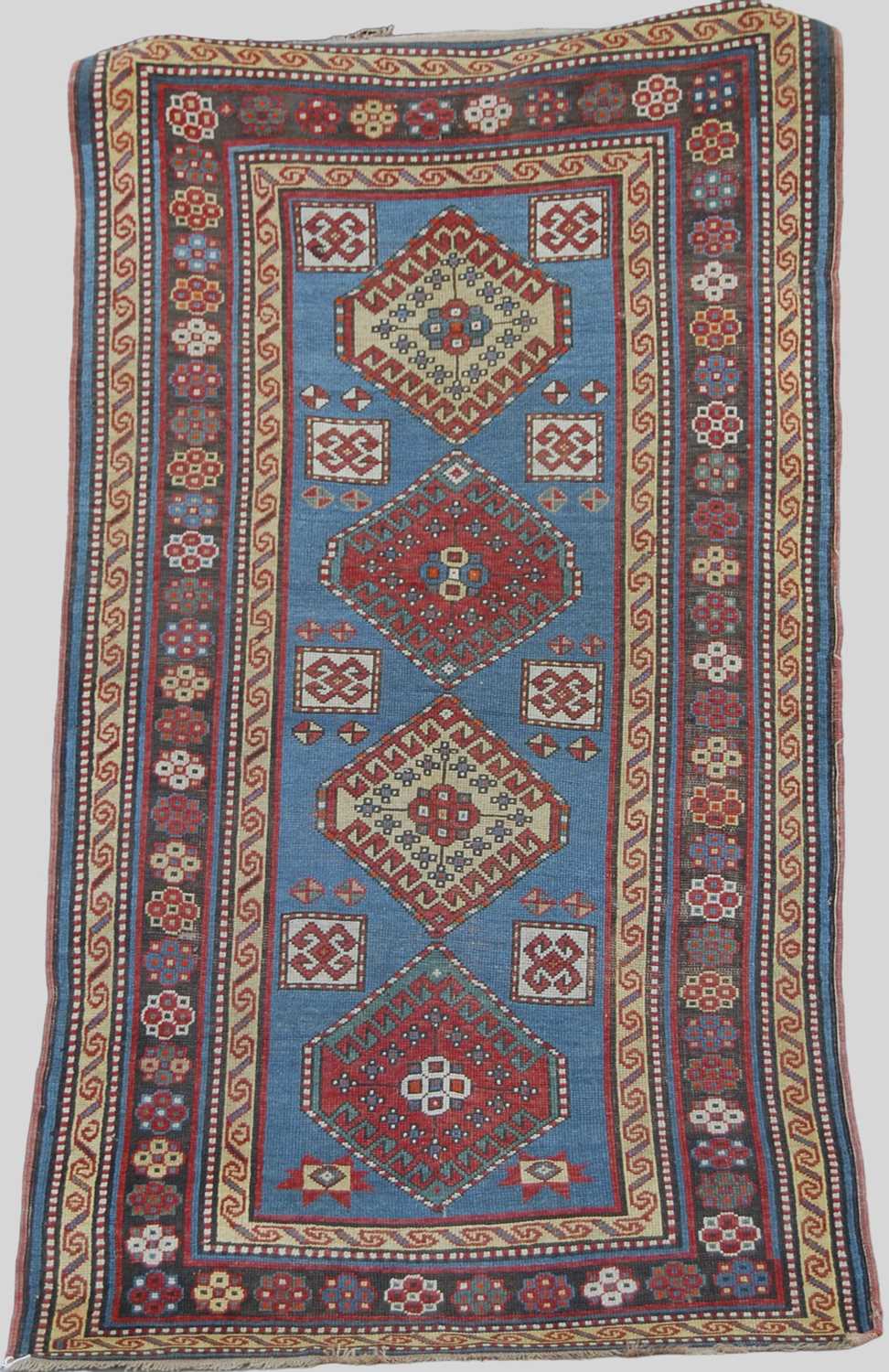 A Persian rug, early 20th century, the rectangular blue ground centred with four lozenge shaped