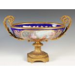 A late 19th century Sevres style porcelain gilt metal mounted twin-handled table centrepiece, the